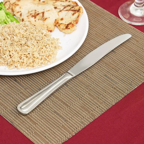 World Tableware 407 5501 Calais 10x22 18/8 Stainless Steel Extra Heavy Weight Solid Handle Dinner Knife with Serrated Blade - 12
