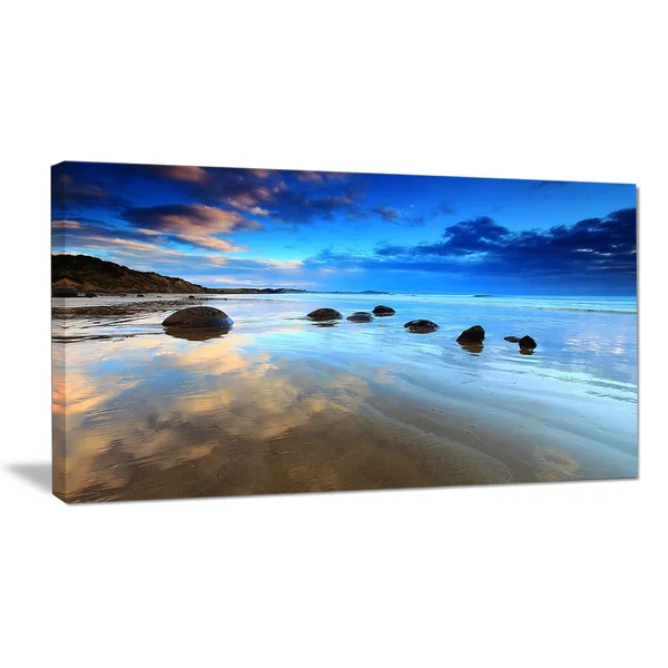 Design Art 'Cloudy Sky Over Moeraki Boulders' Photographic Print on Wrapped Canvas, Size: 16 inch H x 32 inch W x 1 inch D, Blue